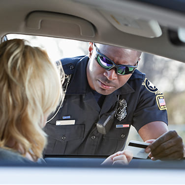 A law enforcement officer speaks with a driver on Saturation Saturday